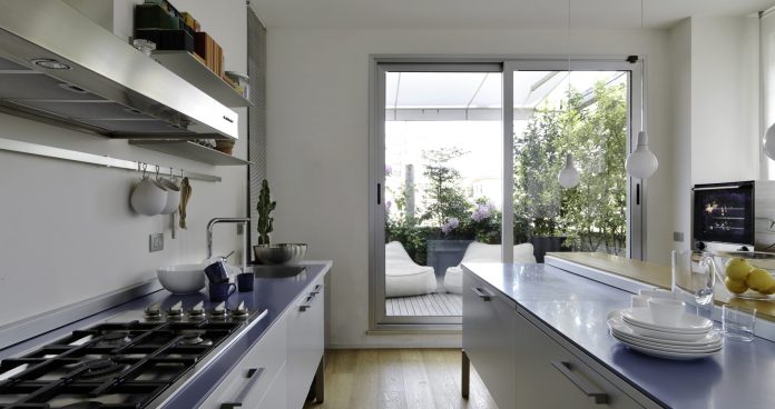 interior view of a modern kitchen with wooden floor overlooking on the terrace